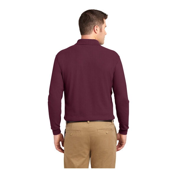 A man wearing a burgundy Port Authority® long sleeve polo.