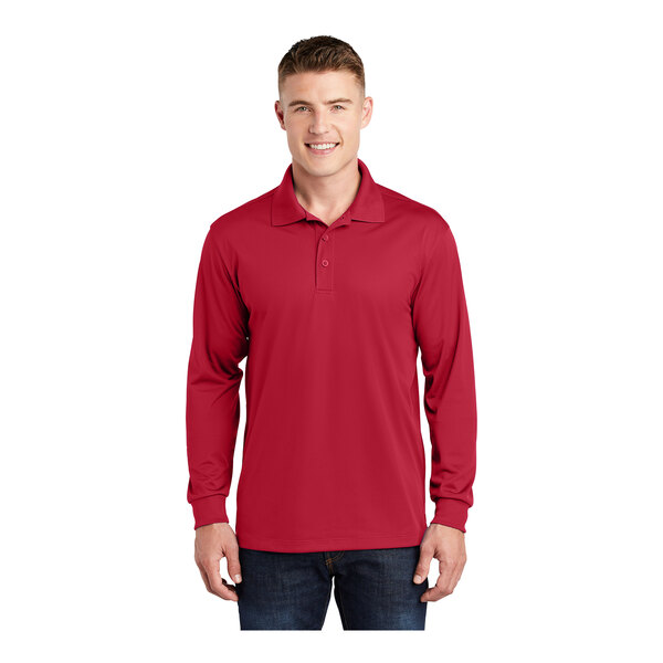 A man wearing a deep red Sport-Tek long sleeve polo shirt.