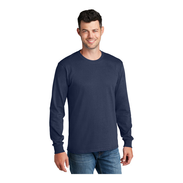 A man wearing a navy Port & Company long sleeve t-shirt.