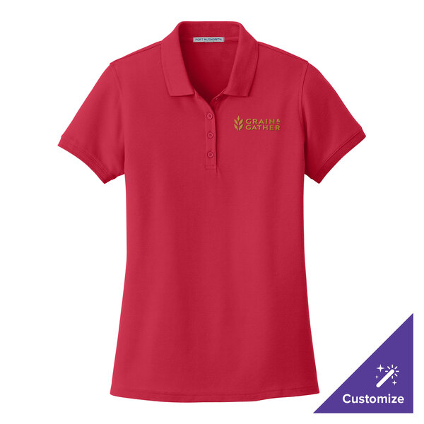 A Port Authority women's rich red short sleeve polo shirt with a logo on it.