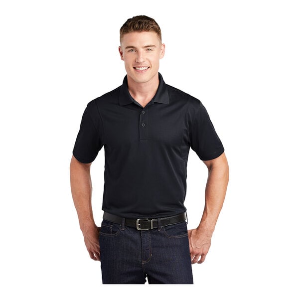 A man wearing a black Sport-Tek moisture-wicking polo shirt.