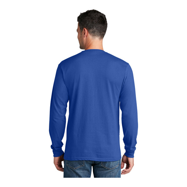 A man wearing a royal blue Port & Company long sleeve T-shirt.