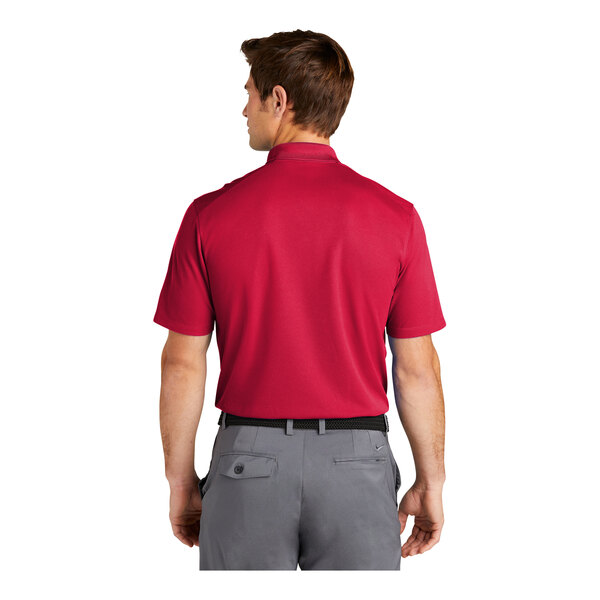 A man wearing a red and grey Nike Polo shirt.