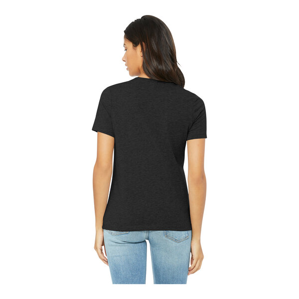 A woman wearing a black Bella + Canvas customizable T-shirt.