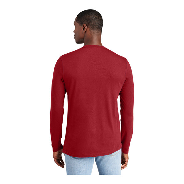 A man wearing a District red long sleeve T-shirt.