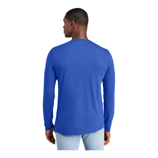 A man wearing a Deep Royal blue long sleeve District T-shirt.
