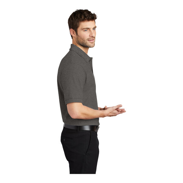 A man wearing a charcoal heather grey Port Authority® silk touch polo shirt.
