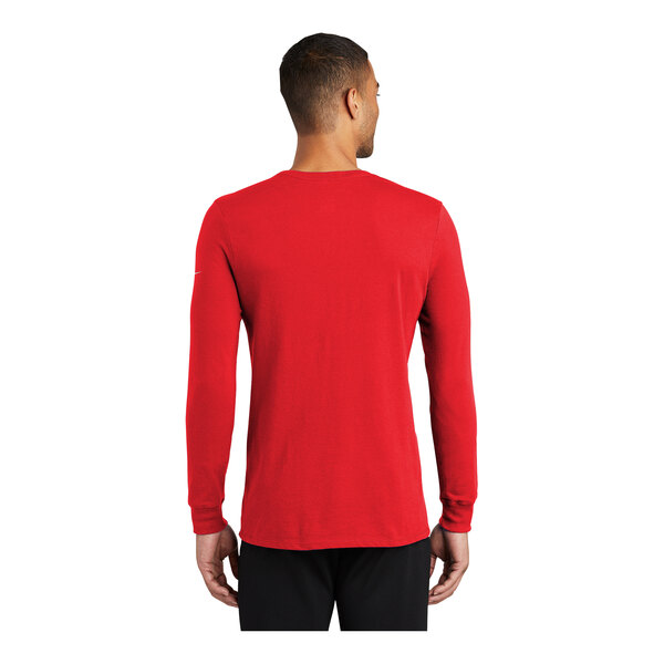 A man wearing a red Nike Dri-FIT long sleeve shirt.