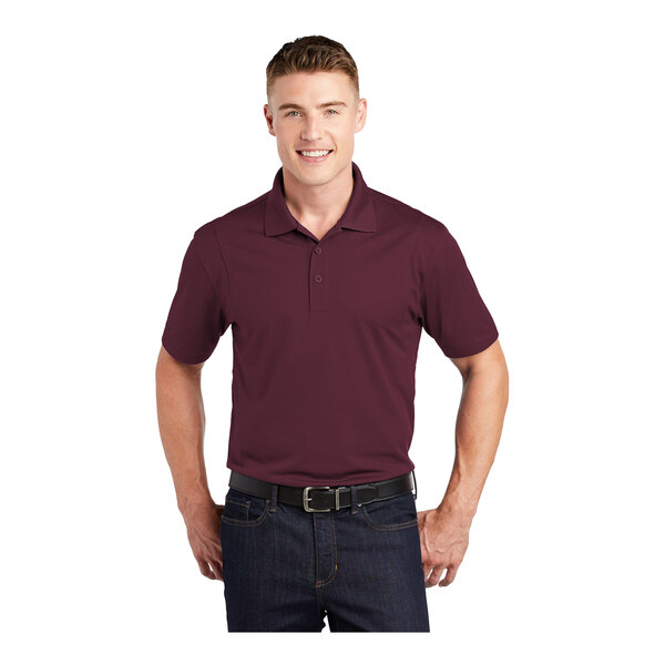 A man wearing a maroon Sport-Tek short sleeve polo.