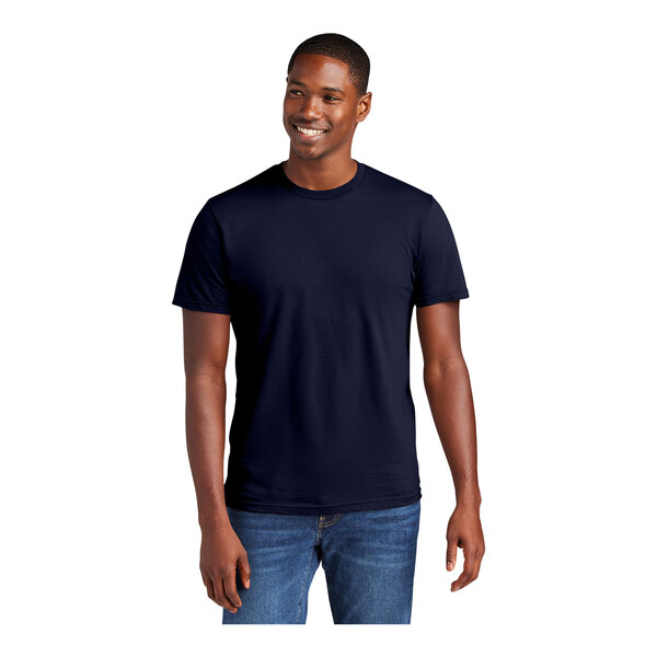 A man wearing a navy District T-shirt smiling.
