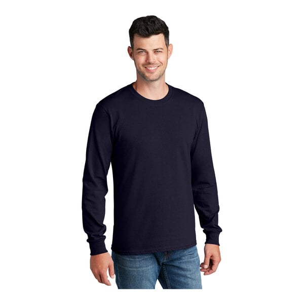 A man wearing a Port & Company long sleeve navy t-shirt.