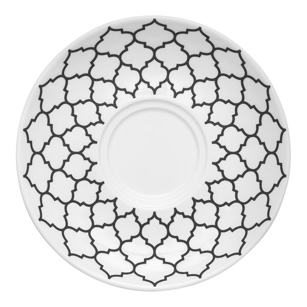 A white Libbey porcelain saucer with black designs.