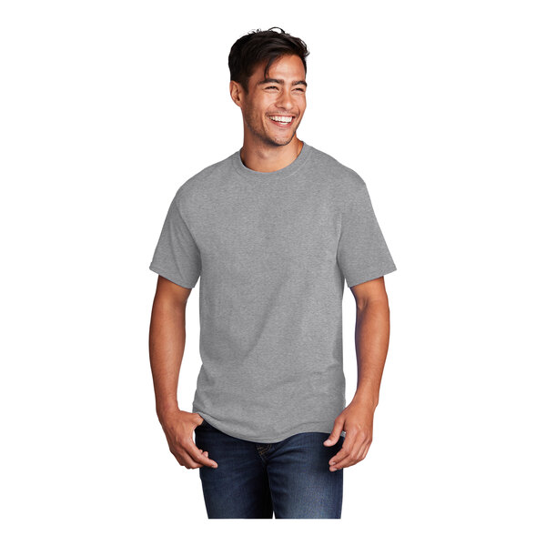 A man wearing a Port & Company athletic heather short sleeve t-shirt in grey.