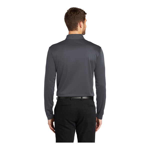 A man wearing a Port Authority steel gray long sleeved polo shirt.