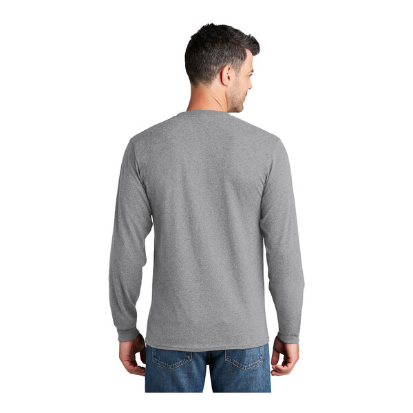 A man wearing a Port & Company long sleeve athletic heather grey shirt.