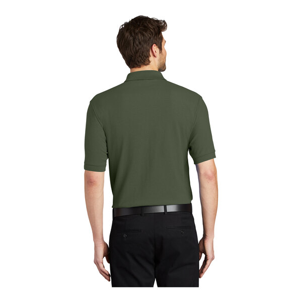 A man wearing a Clover Green Port Authority polo shirt.