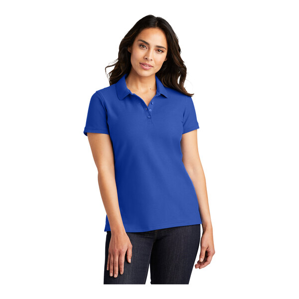 A woman wearing a Port Authority blue pique polo shirt.