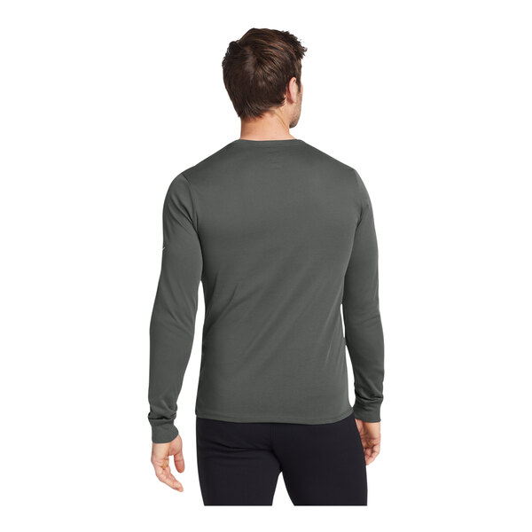 A man wearing a dark grey Nike Dri-FIT long sleeve shirt.