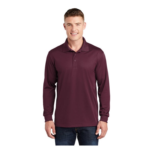 A man wearing a maroon Sport-Tek long sleeve polo shirt.