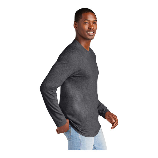 A man wearing a heathered charcoal long sleeve T-shirt.