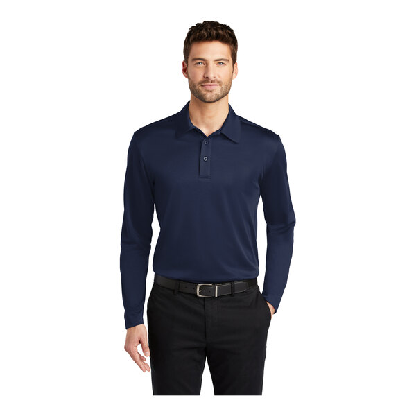 A man wearing a navy Port Authority long sleeve polo.