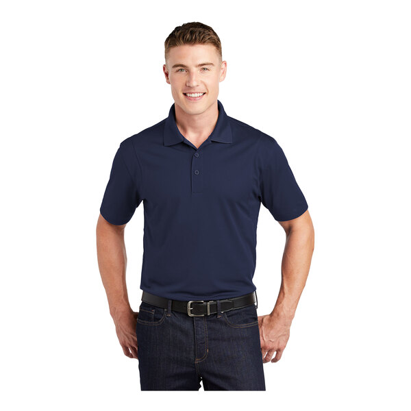 A man wearing a navy Sport-Tek moisture-wicking polo shirt.