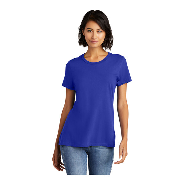 A woman wearing a District deep royal blue combed cotton short sleeve t-shirt.