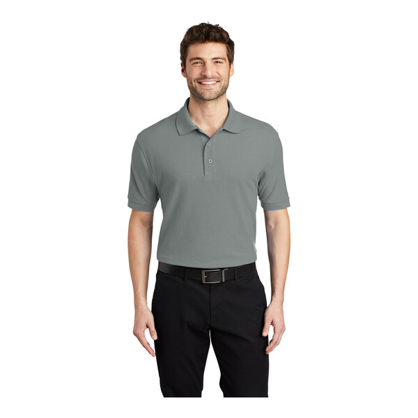 A man wearing a Port Authority Cool Gray Silk Touch Pique Polo shirt.