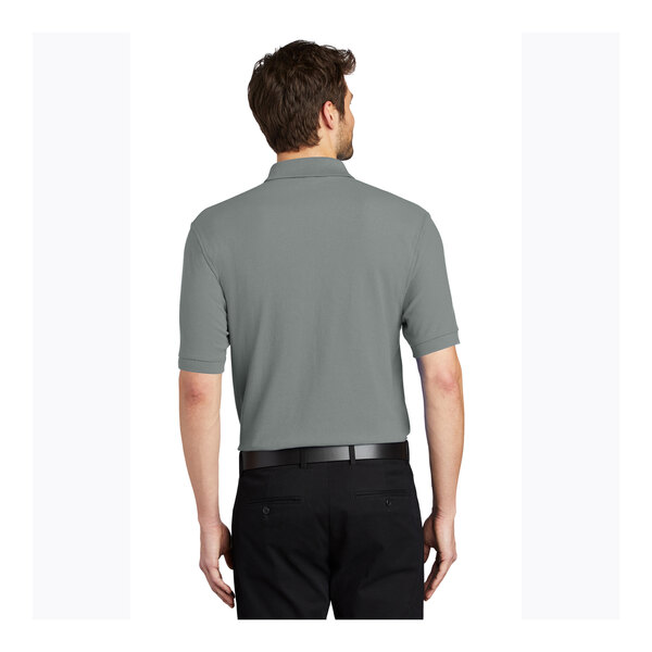 A man wearing a Port Authority Cool Gray Silk Touch Pique Polo shirt.