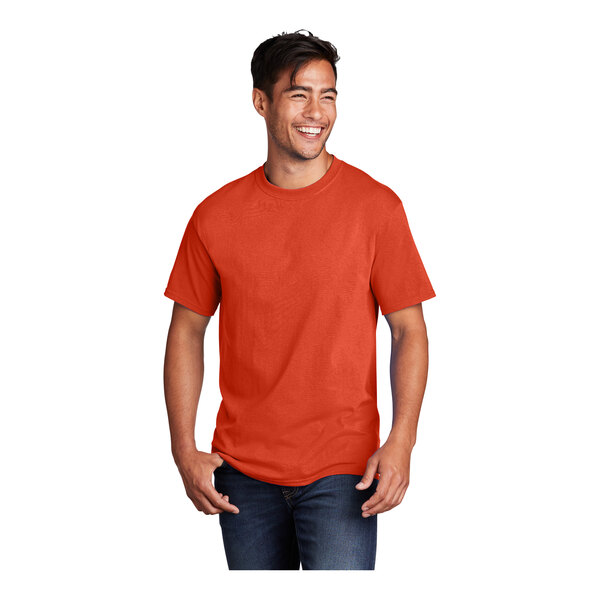 A man wearing an orange Port & Company short sleeve t-shirt.