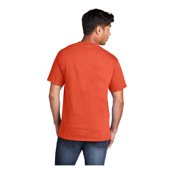 A man wearing a Port & Company orange short sleeve T-shirt.