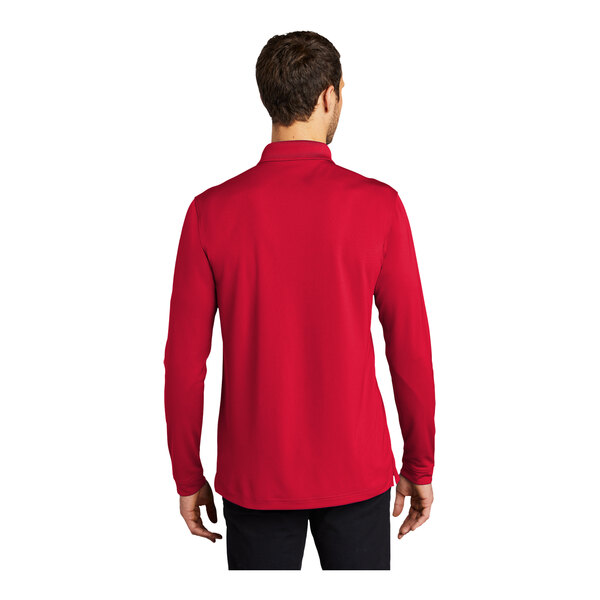 A man wearing a rich red long sleeve Port Authority polo shirt.