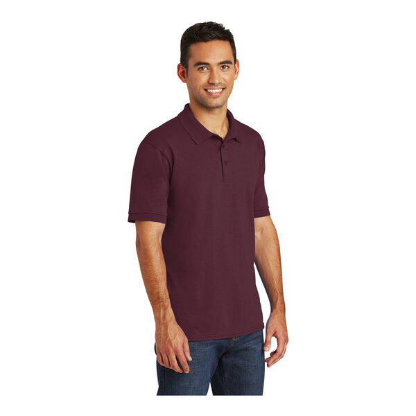 A man wearing a maroon Port & Company jersey knit polo shirt.