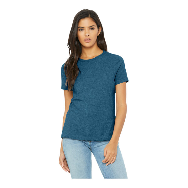 A woman wearing a Bella + Canvas heather deep teal customizable short sleeve T-shirt.