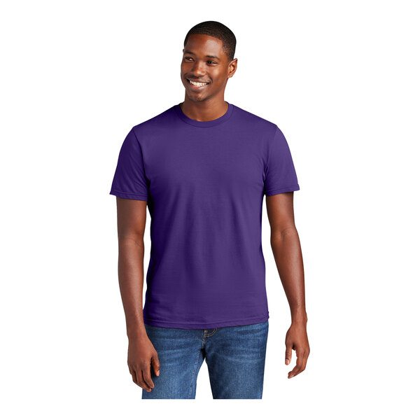 A man wearing a District purple short sleeve t-shirt.