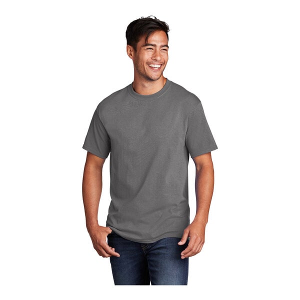 A man wearing a Port & Company medium gray short sleeve T-shirt.