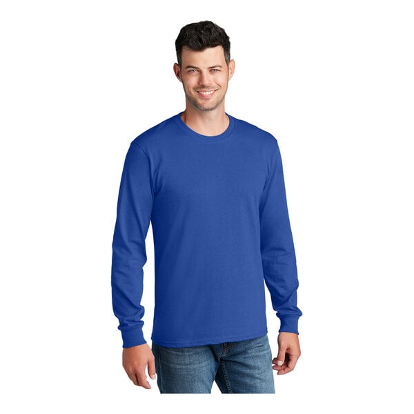 A man wearing a Port & Company royal blue long sleeve t-shirt.