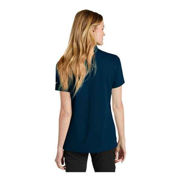 A woman wearing a navy Nike polo shirt.