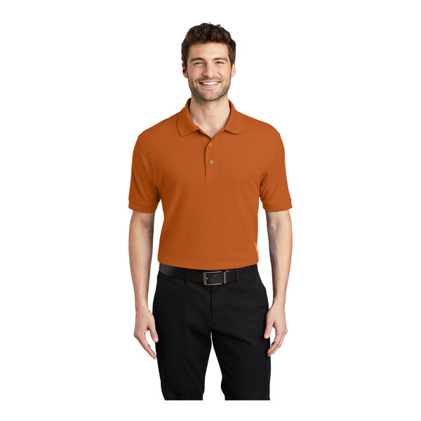 A man wearing a Texas orange Port Authority silk touch polo shirt.