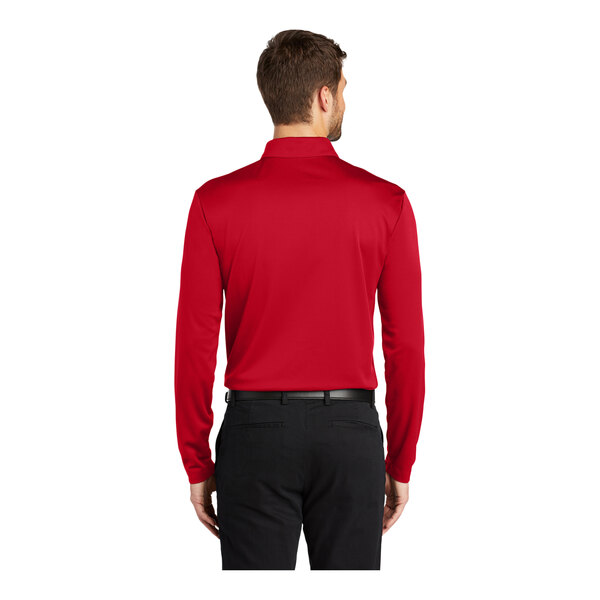 A man wearing a red Port Authority polo shirt.