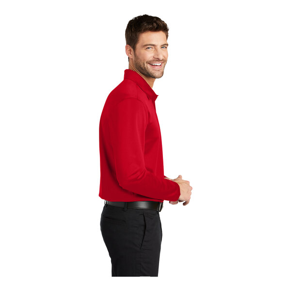A man wearing a red Port Authority® long sleeve polo.