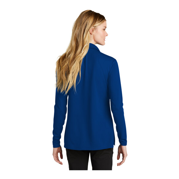 A woman wearing a Nike Gym blue long sleeve polo.