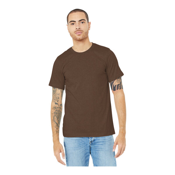 A man wearing a heather brown Bella + Canvas t-shirt.