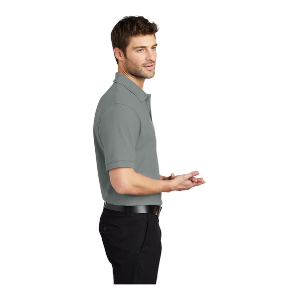 A man wearing a Port Authority Cool Gray silk touch pique polo shirt.
