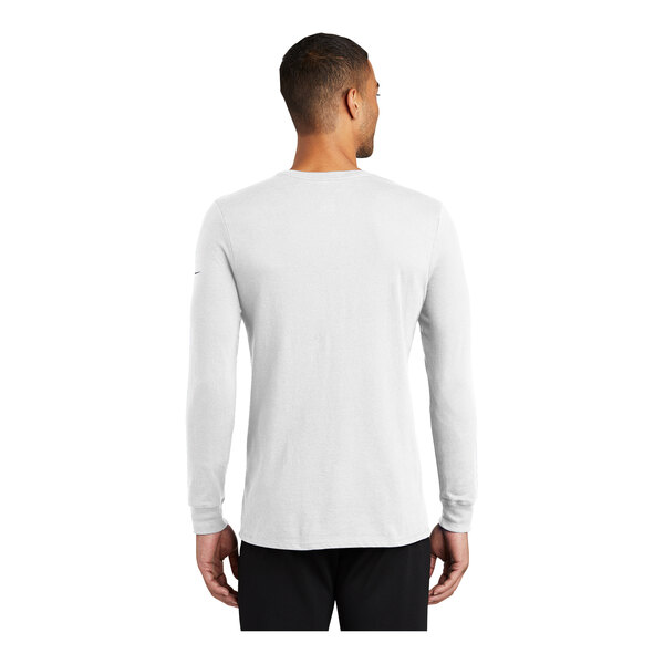 A man wearing a white Nike Dri-FIT long sleeve shirt.