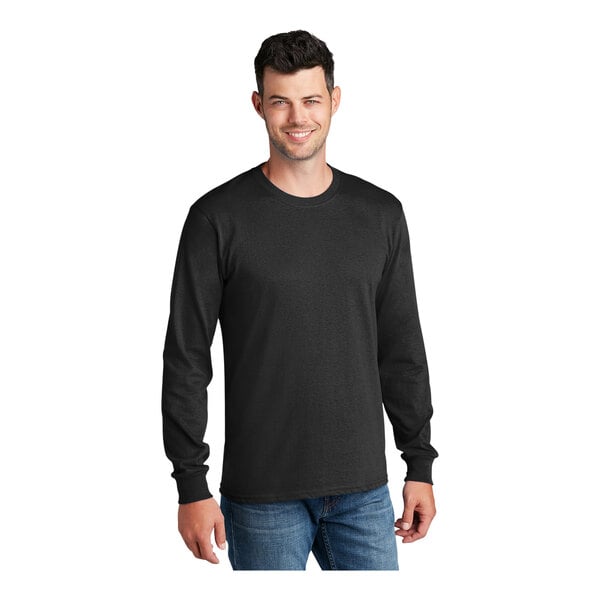 A man wearing a Port & Company long sleeve black T-shirt.