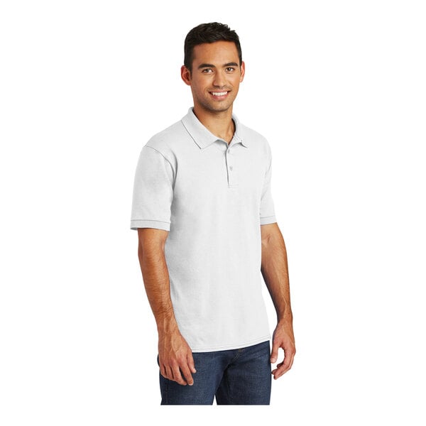 A man wearing a white Port & Company short sleeve jersey polo shirt.