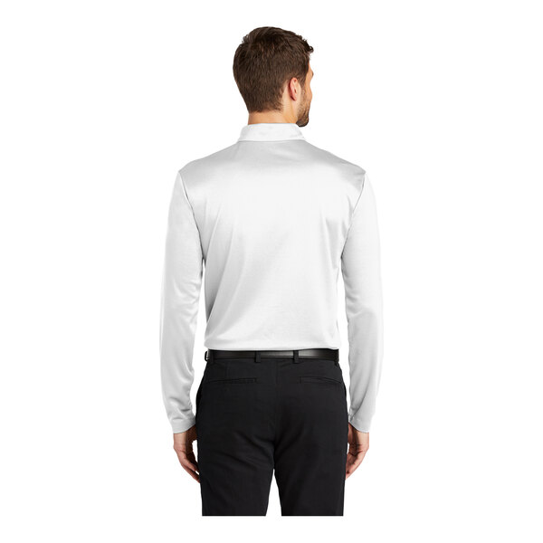 A man wearing a white Port Authority long sleeve polo shirt.