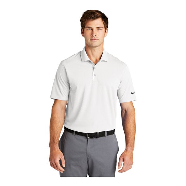 A man wearing a white Nike Dri-Fit polo.