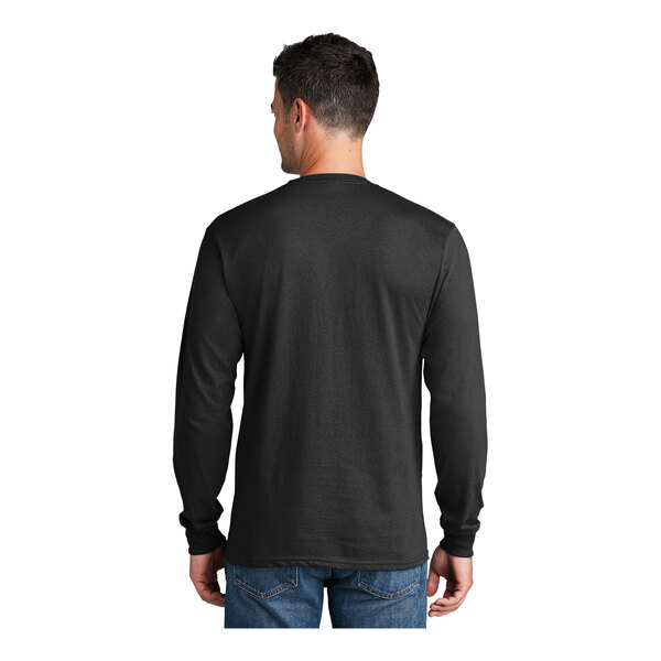 A man wearing a jet black Port & Company long sleeve t-shirt.